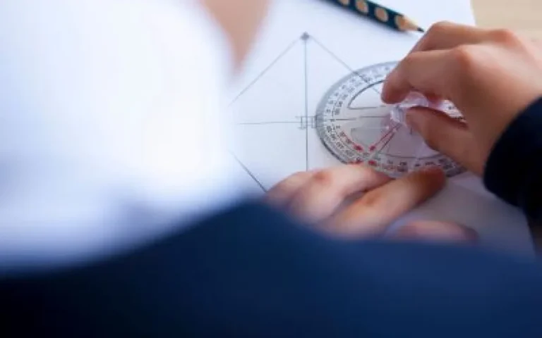 Someone using a protractor on a page