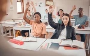 Students raising their hand in class